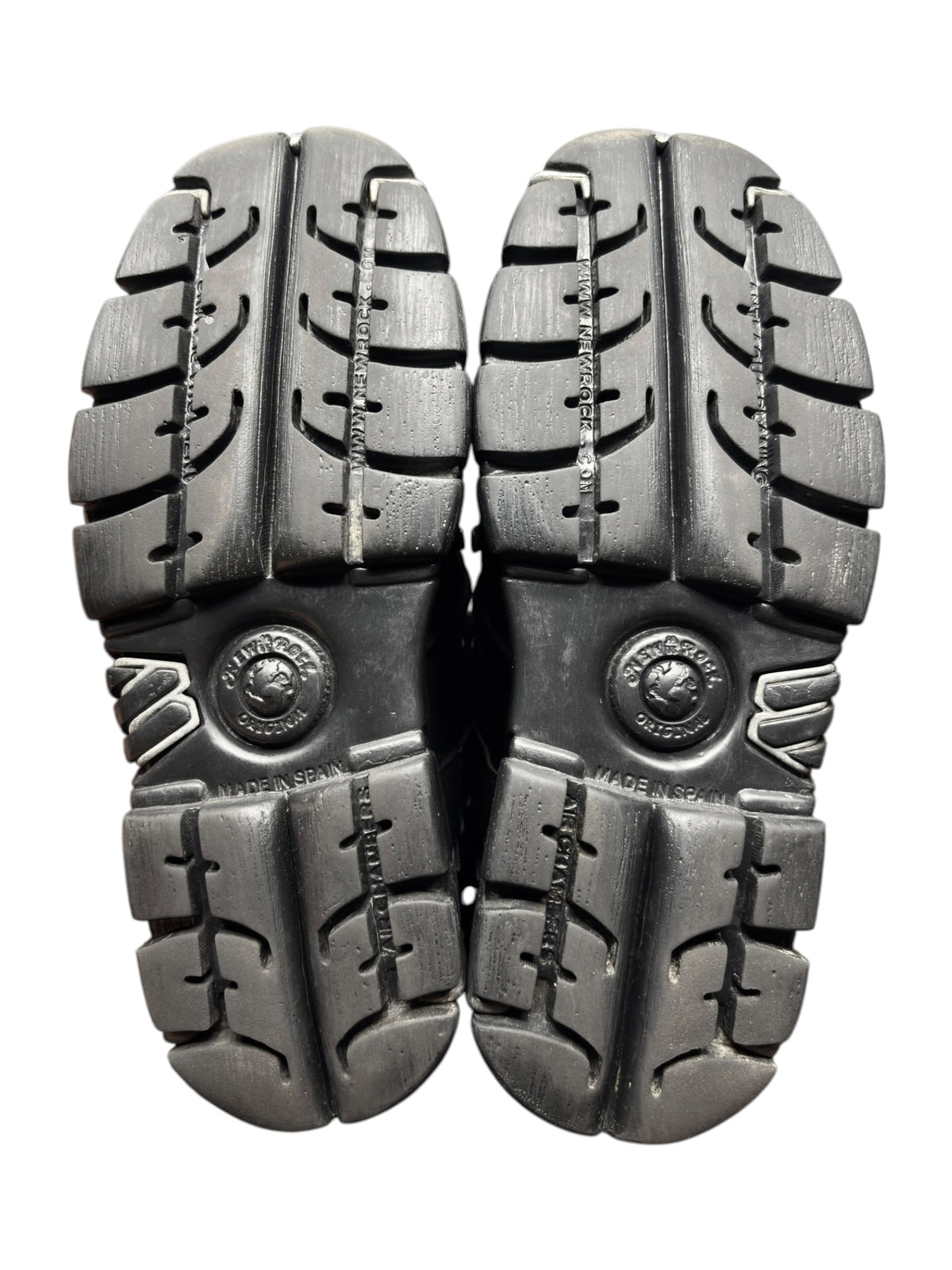 Pair of black platform boot outsoles with deep tread and traction grooves.