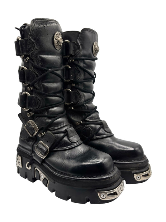 Black knee-high leather boots with side buckles, straps, and rugged platform sole