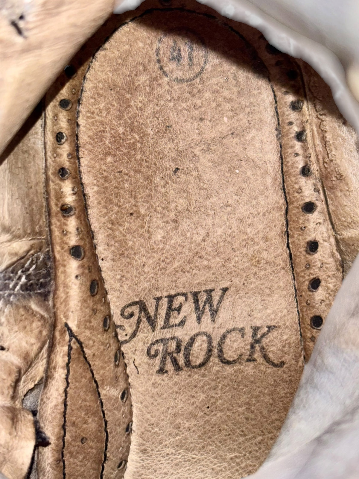 Vintage platform boot insole with “NEW ROCK” logo, worn beige interior lining.
