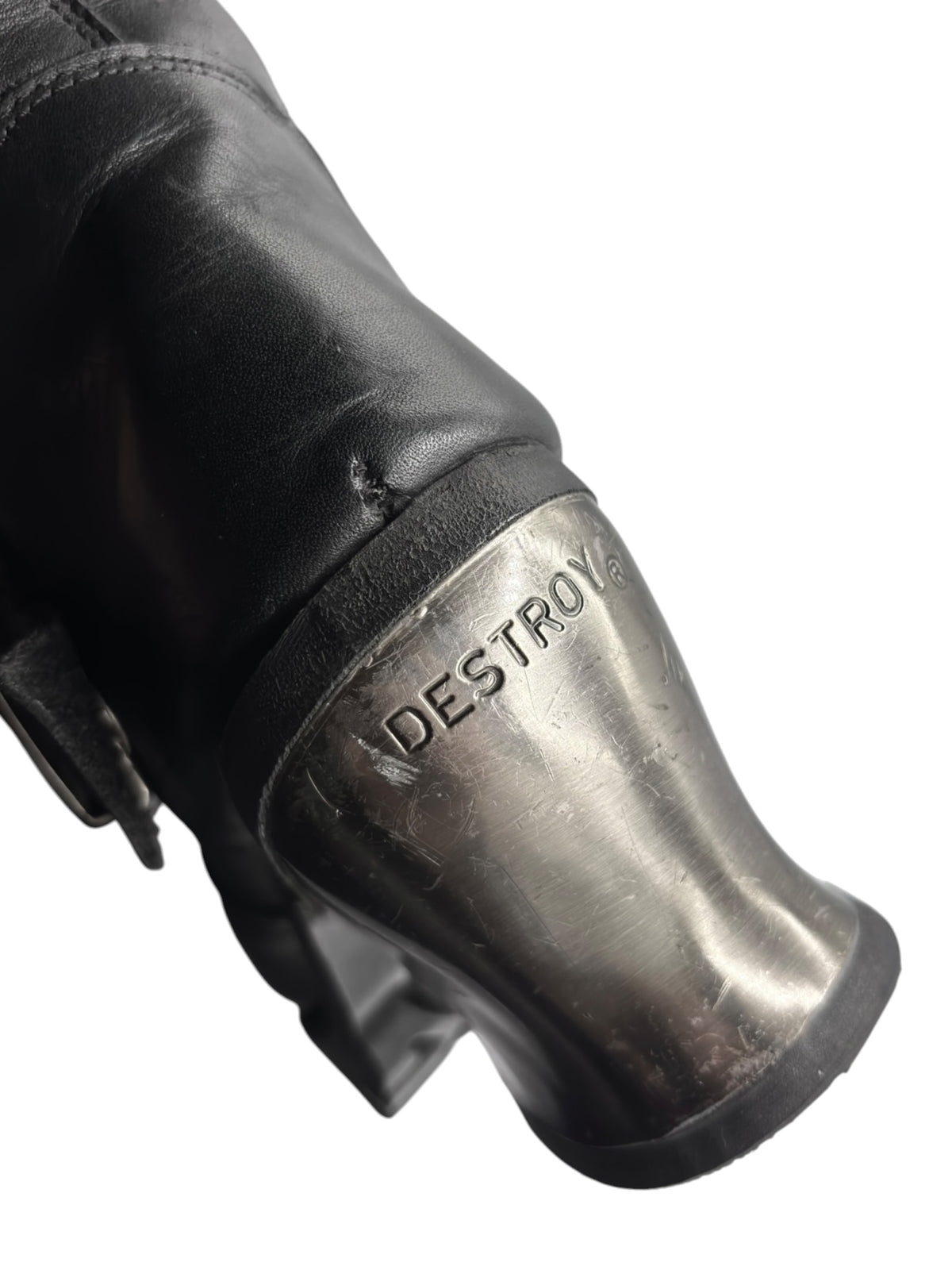 Boot heel and shaft close-up with embossed 'DESTROY' logo on dark leather