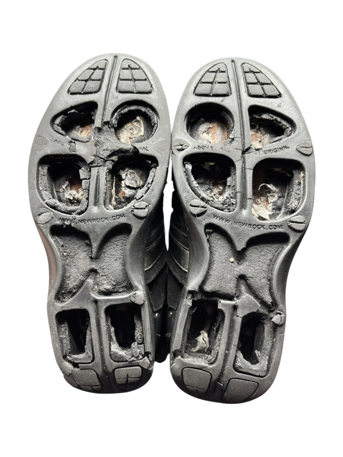 Pair of worn sneaker outsoles with tread pattern and molded traction blocks