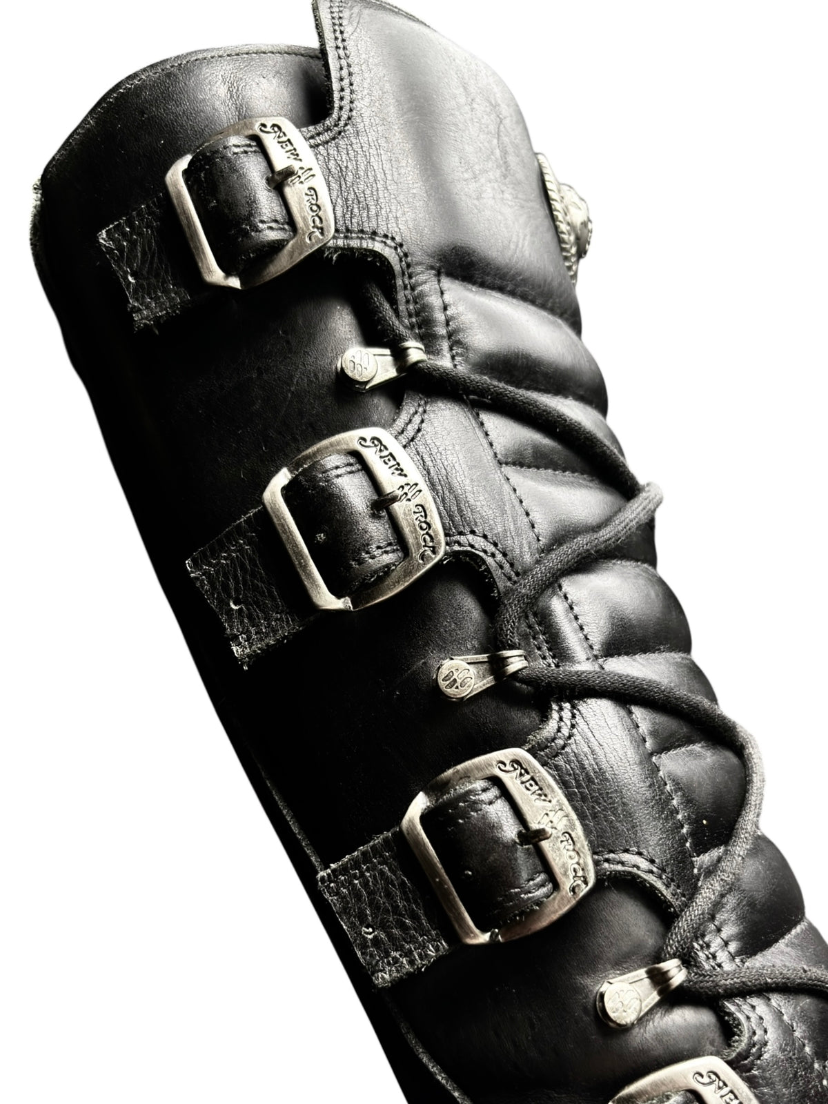 Black leather knee-high boots with buckle straps and lace-up front details