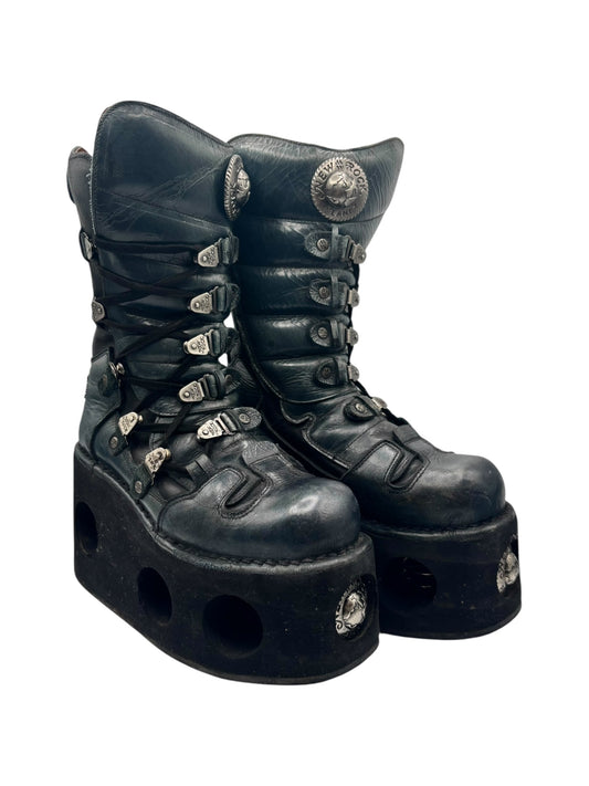Dark green lace-up platform boots with thick outsole and multiple strap buckles