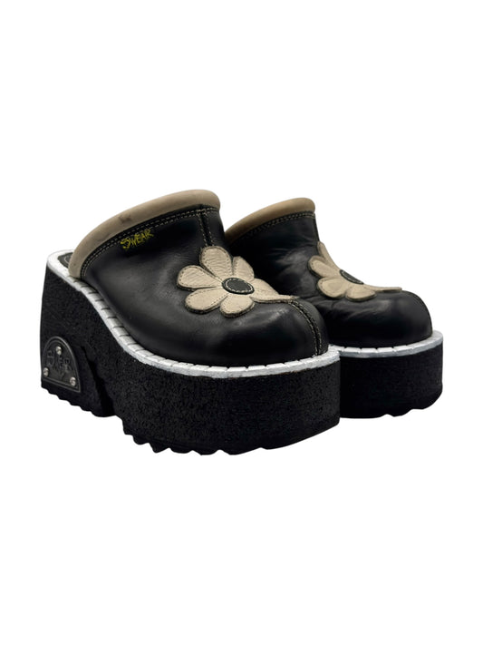 Black leather platform clogs with white flower applique and thick sole