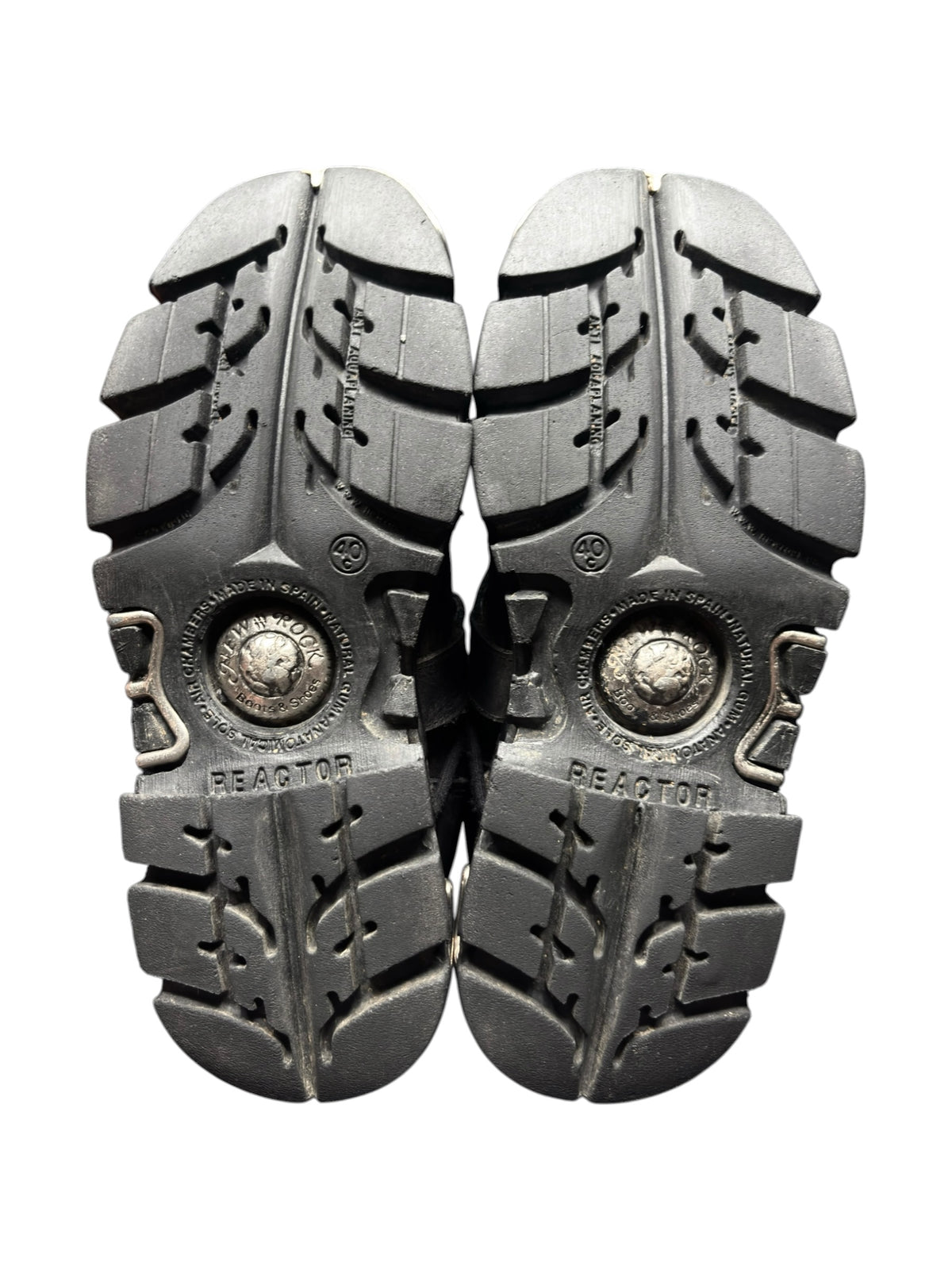 Pair of black chunky boots showing treaded outsoles and round sole logos