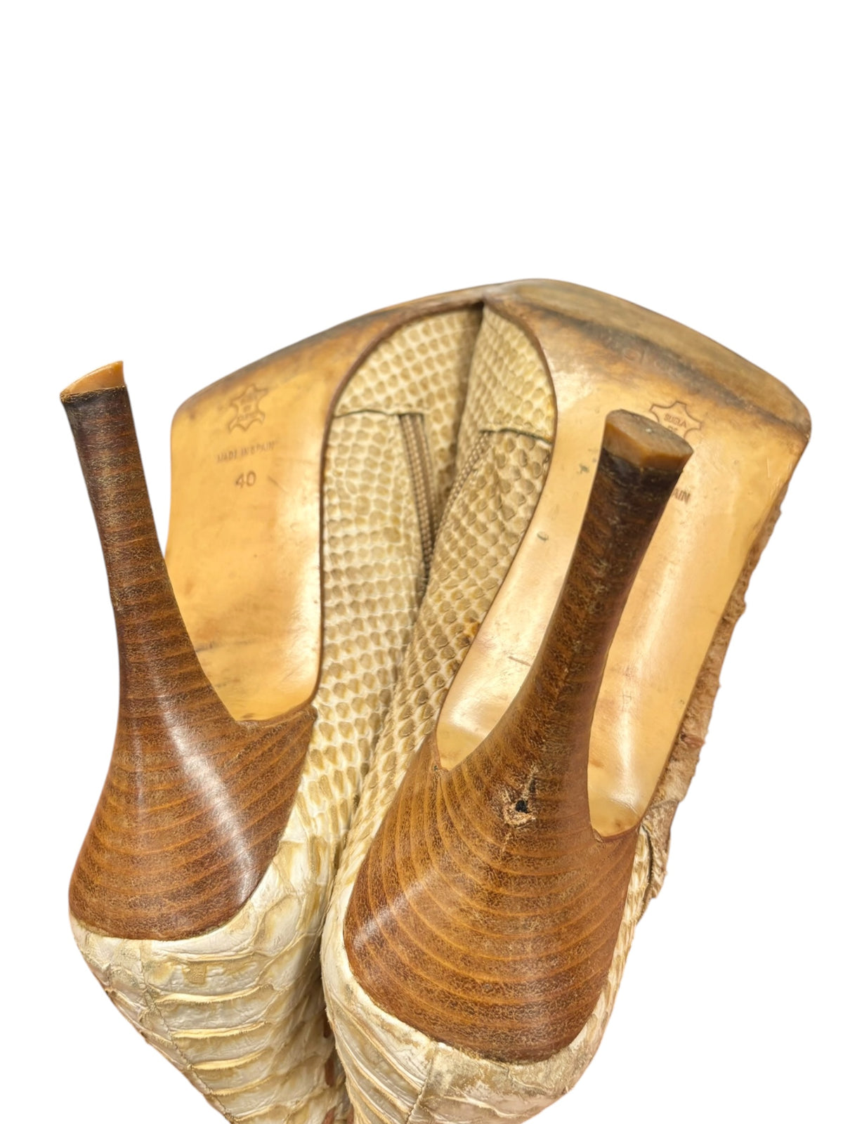 Beige snake-pattern leather boots with stacked heels, back view