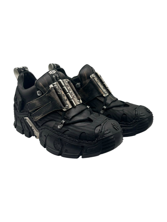 Black platform lace-up boots with thick tread sole and metal buckle on each side