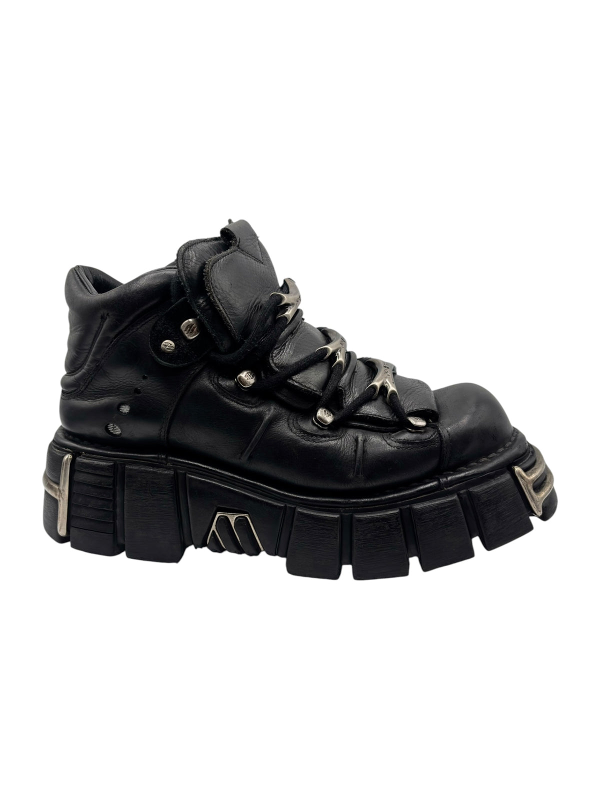 Black lace-up platform boot with decorative side metal trim and thick tread sole