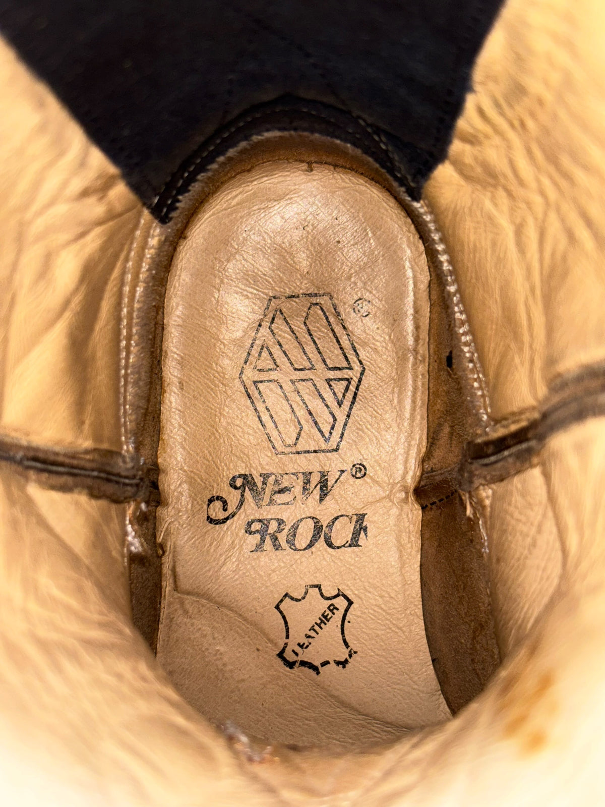 Beige cowboy boot insole with NEW ROCK logo and leather emblem