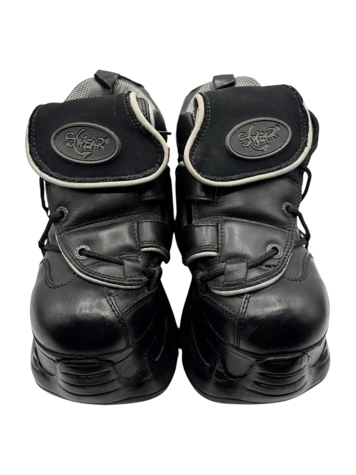 Black platform boots with oval “Swear” logo patch on the back, top view.