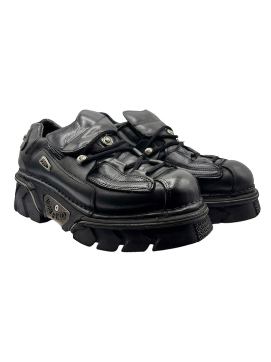 Black leather platform lace-up boots, side view with metal eyelets and thick sole