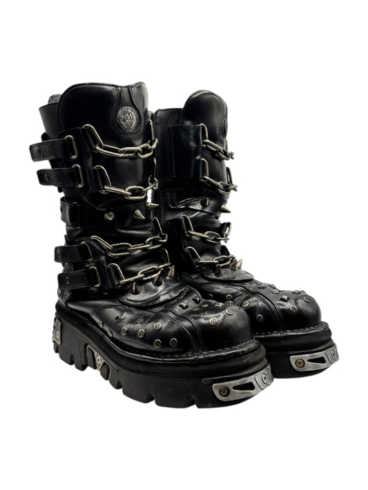Black studded chain boots with thick lug sole, metal chains and buckled straps