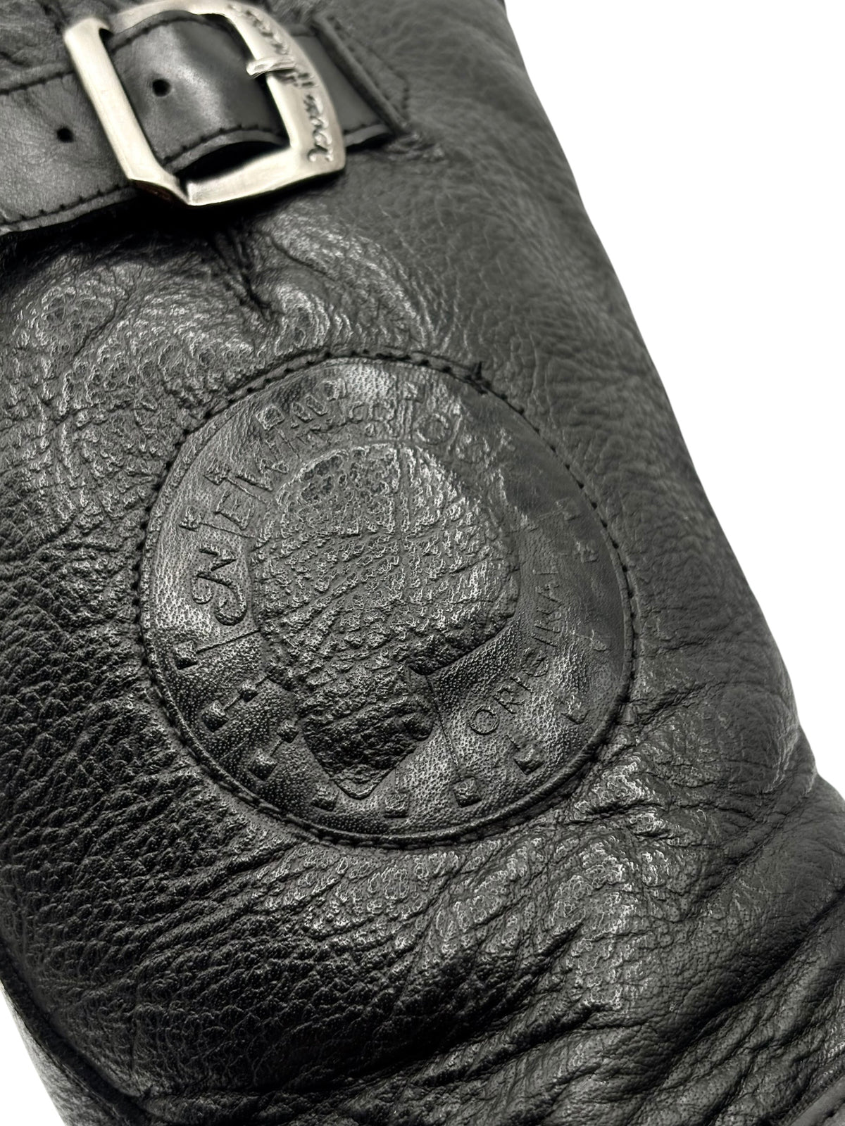 Black leather biker boots with embossed circular ankle logo detail