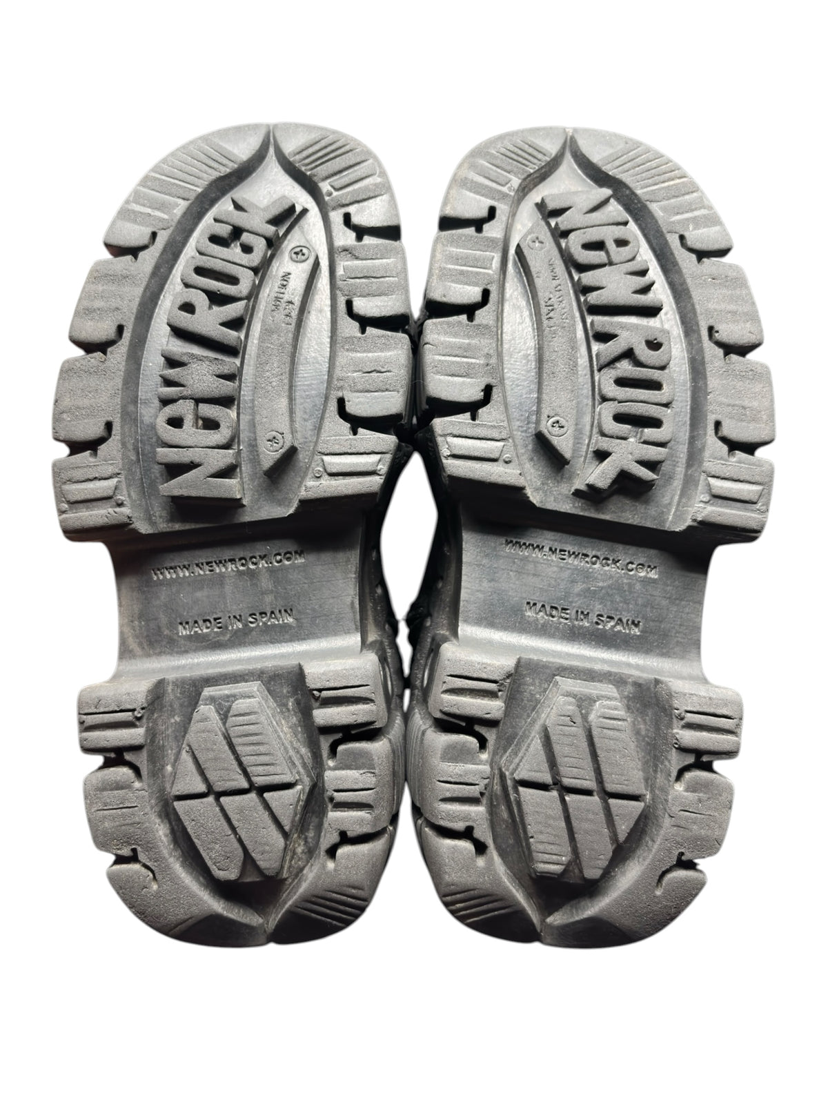 Pair of black platform boot soles showing rugged tread and brand embossing.