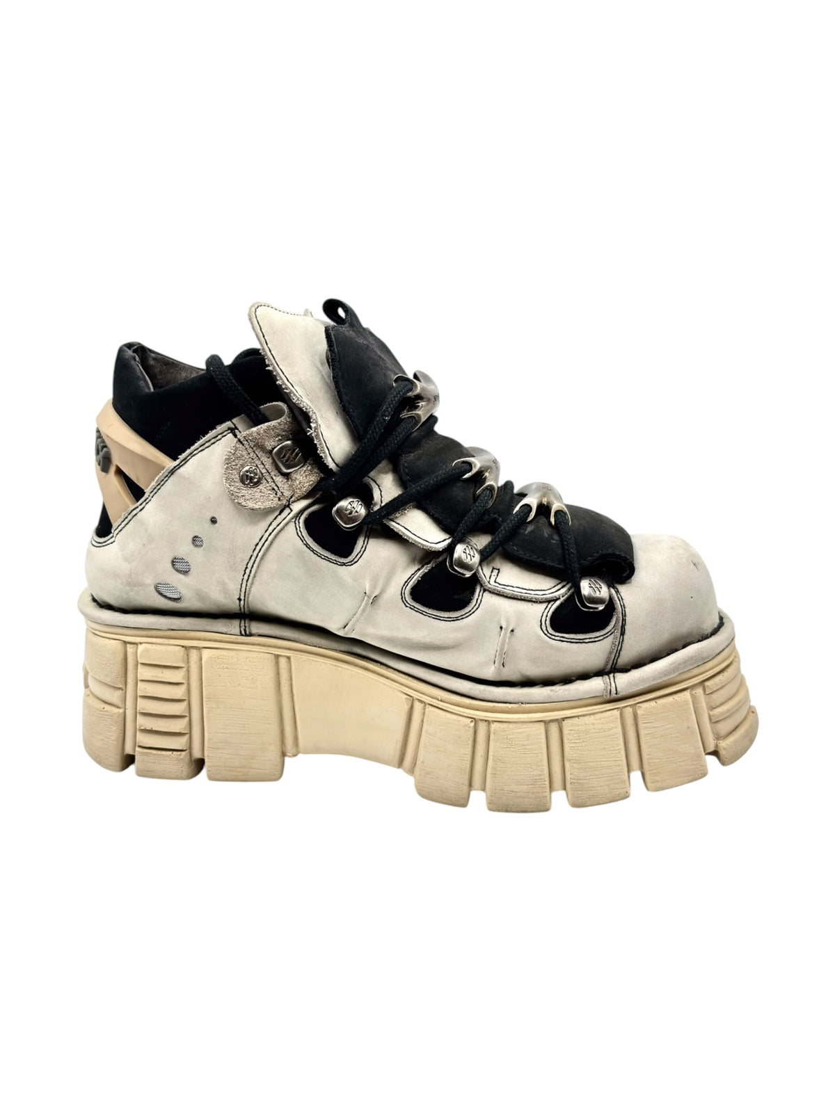 Beige leather platform lace-up boot with black accents and chunky tan tread sole