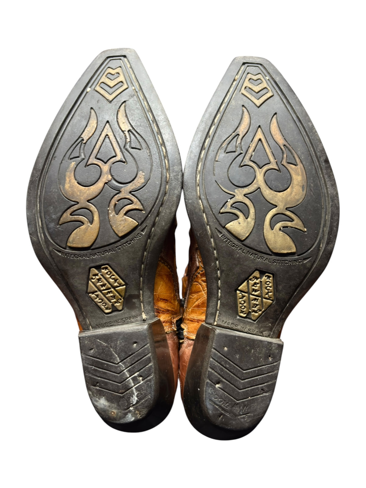 Pair of boot outsoles in brown and dark tones with decorative flame cutouts