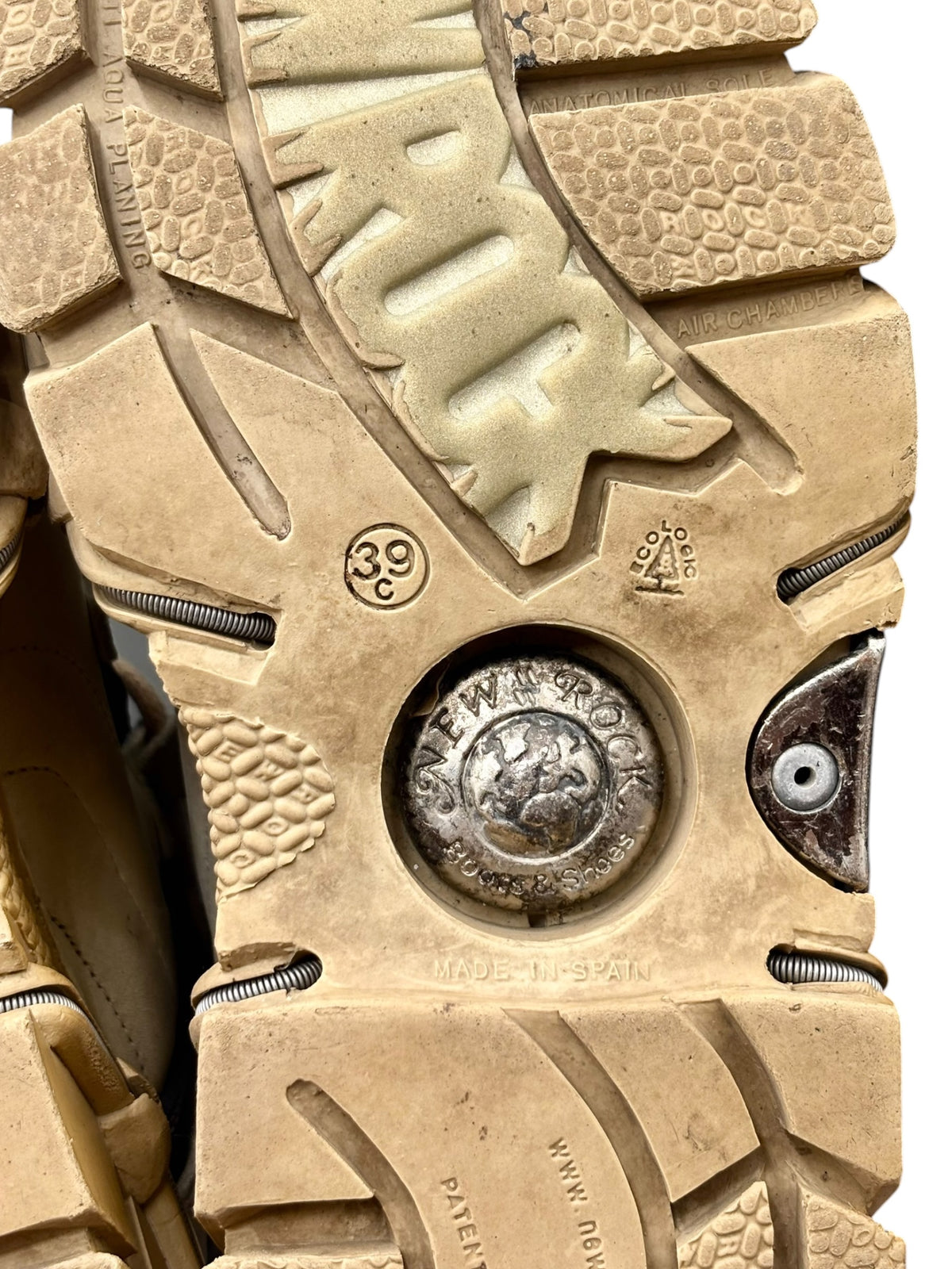 Beige lug outsole with traction tread and metal logo accents on platform boots