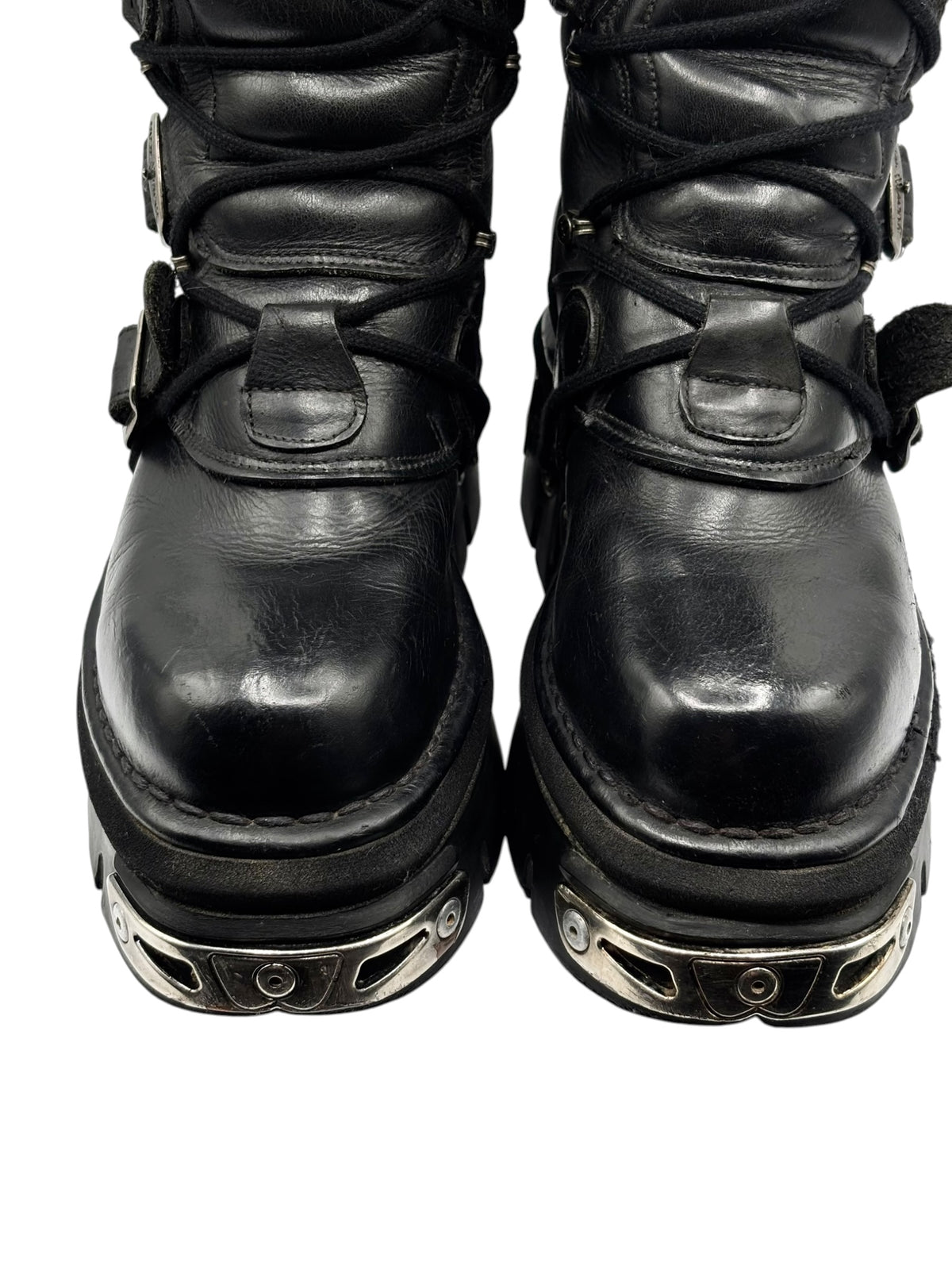 Black knee-high leather boots with metal-studded trim and chunky outsole