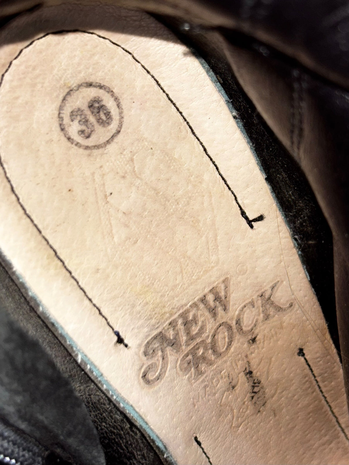 Flame boots insole close-up with printed size label and stitching detail