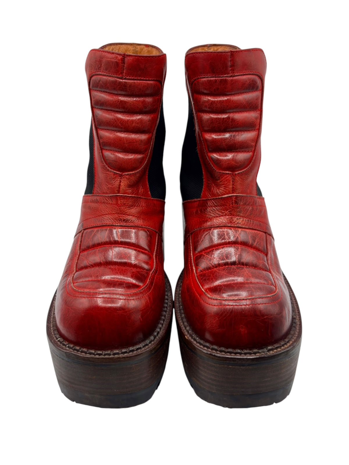 Red leather ankle boots rear view with vertical panel stitching and dark stacked heels