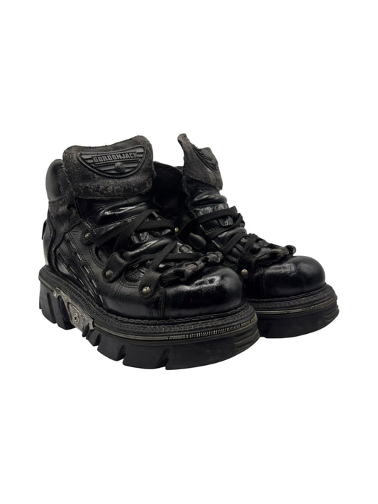 Black leather platform boots with lace-up front, logo tongue, and chunky tread sole