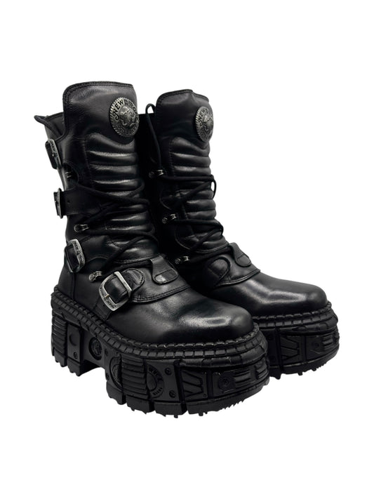 Black mid-calf platform boots with buckle straps, lace-up front, angled view