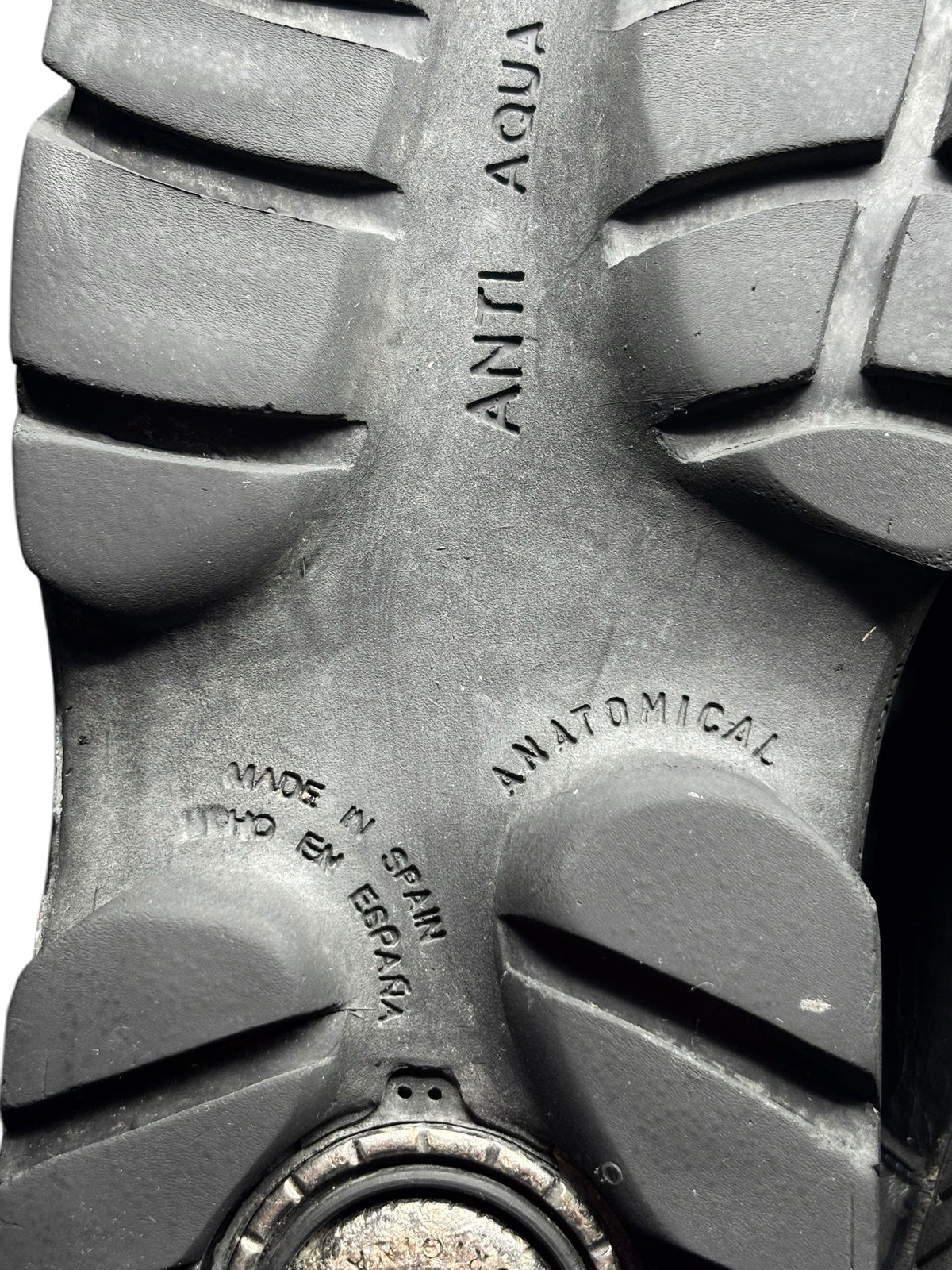 Close-up of black boot outsole tread with embossed brand markings