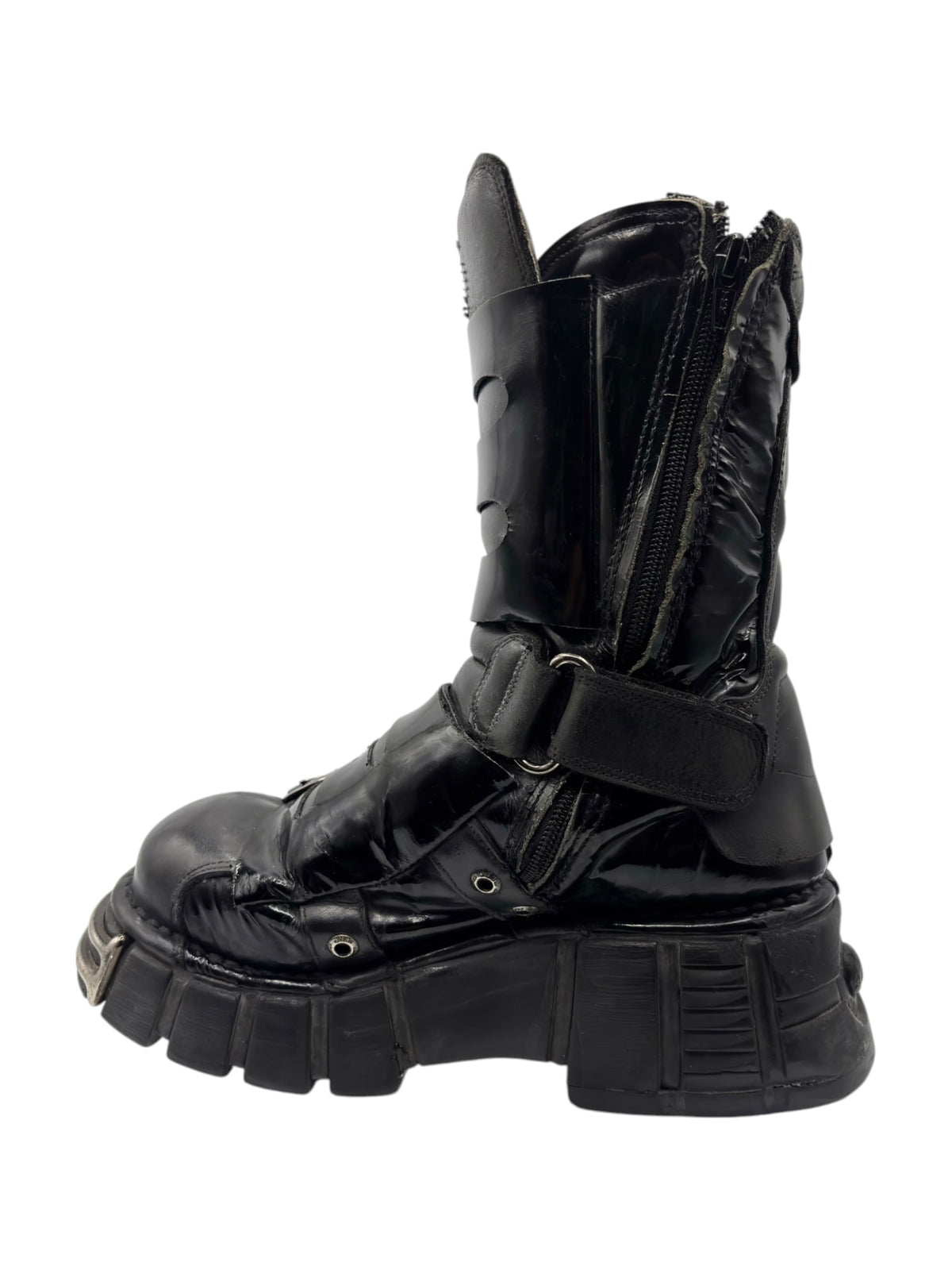 Vintage black leather boot side view with strap hardware and thick platform sole