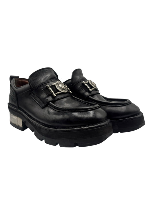 Black platform loafers with gold-toned buckle detail and chunky lug sole