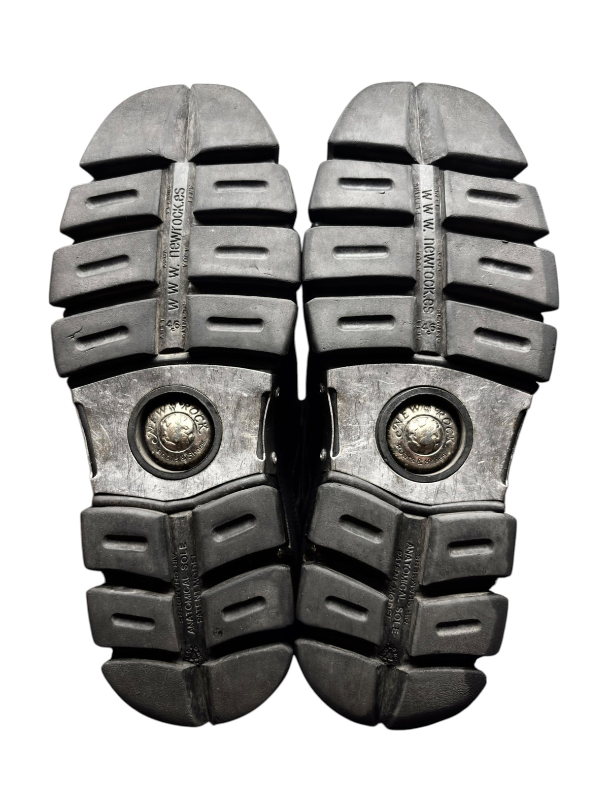 Pair of platform boot outsoles with chunky tread and circular metal logo