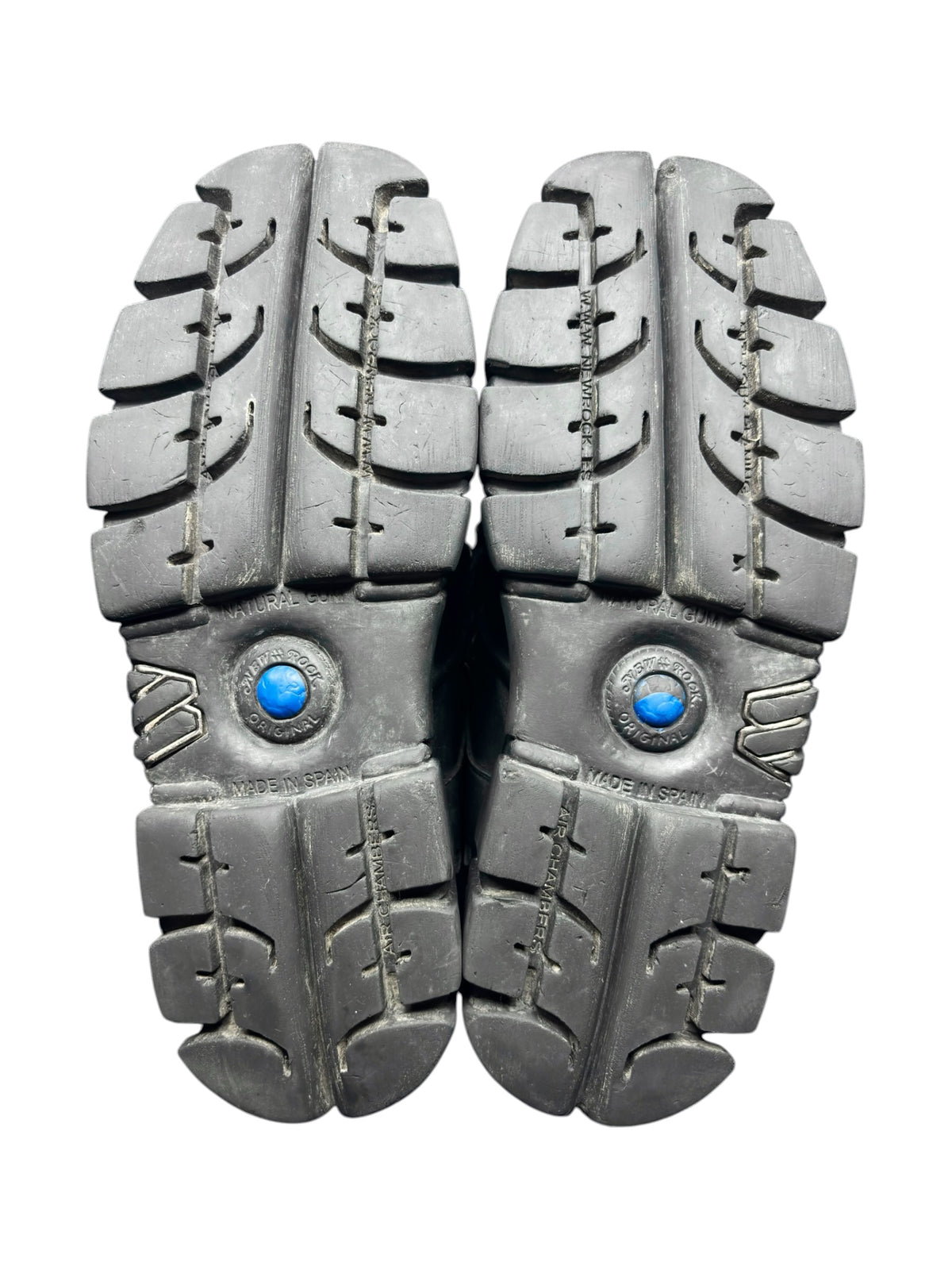 Pair of platform boots showing rugged tread outsole with blue logo medallions