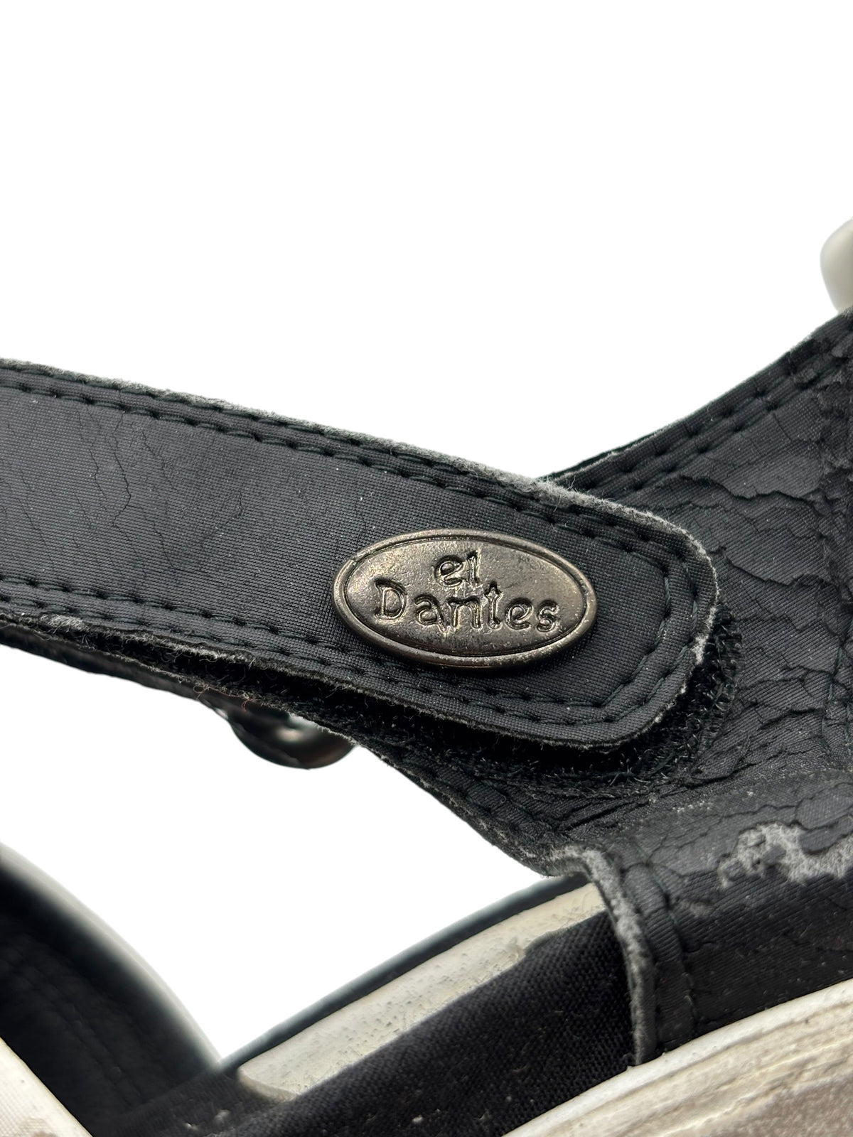 Black slingback sandal strap with oval logo and stitched edge