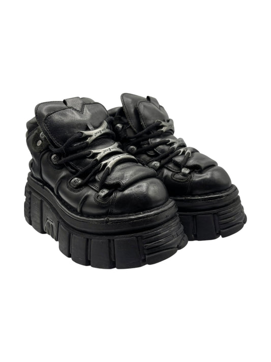Black platform lace-up boots with chunky tread sole and straps