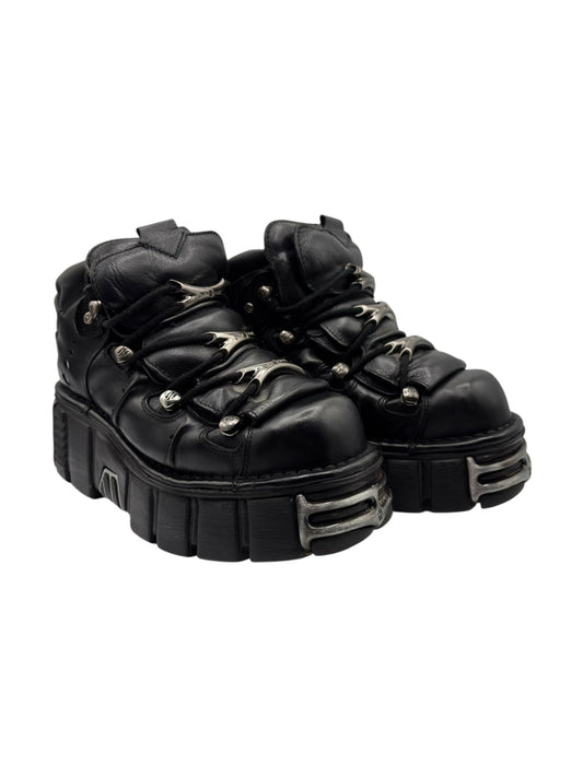 Black leather lace-up platform boots with buckled straps and thick molded sole