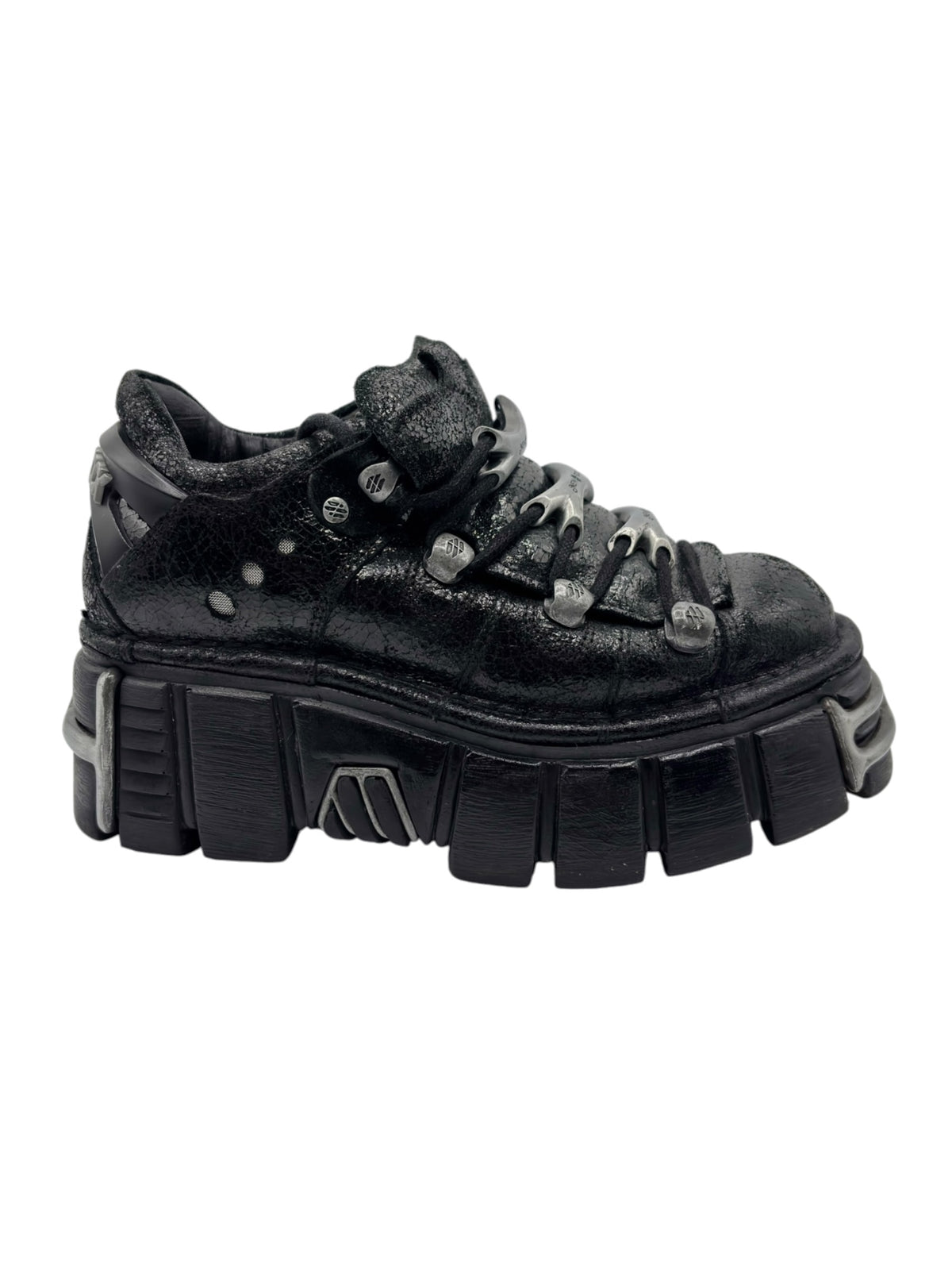 Black platform boots angled side view with lace-up hardware and tread blocks