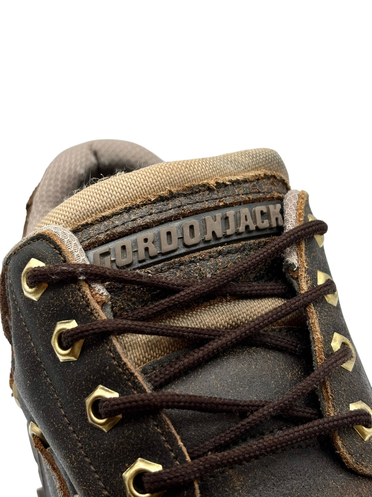 Brown leather lace-up boots with GORDONJACK logo patch on the tongue