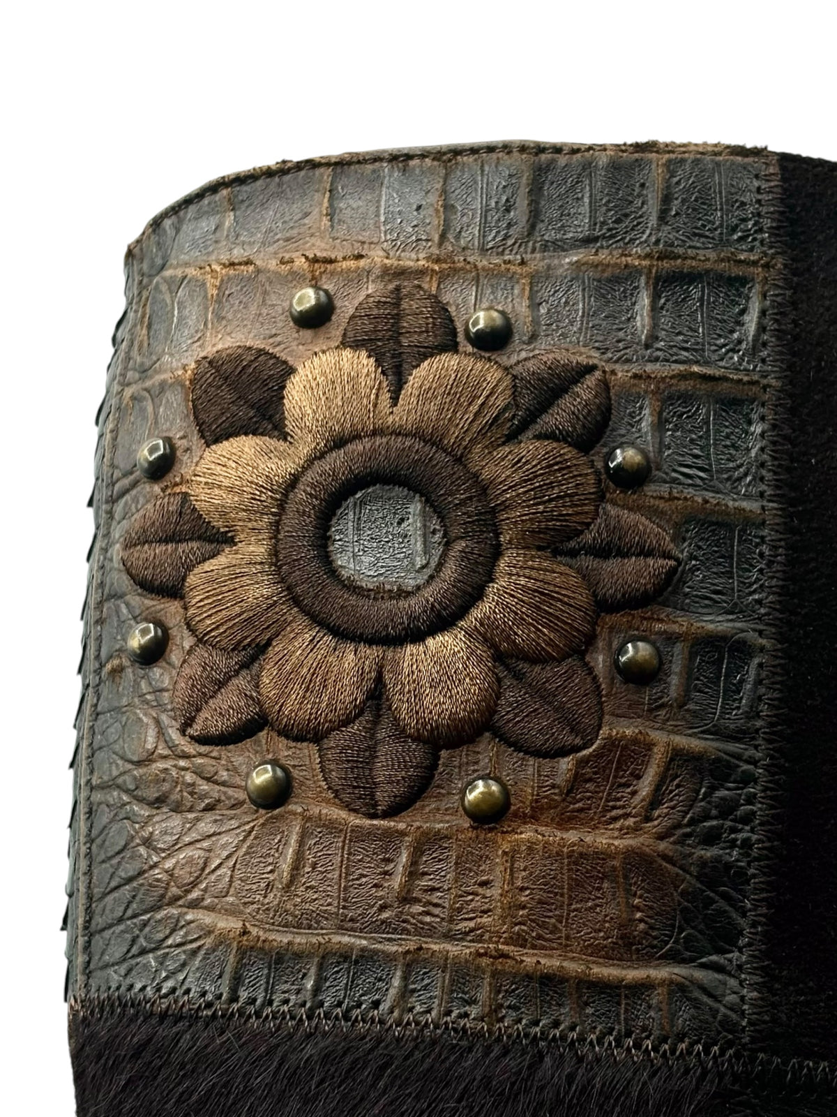 Vintage knee-high leather boot with floral stitched patch, bronze studs, and snap dome details