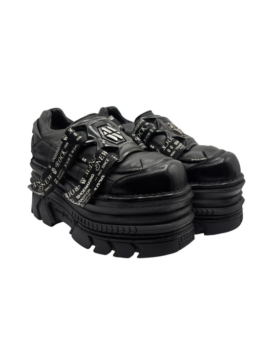 Black leather mega-platform lace-up boots with chunky tread sole and side straps