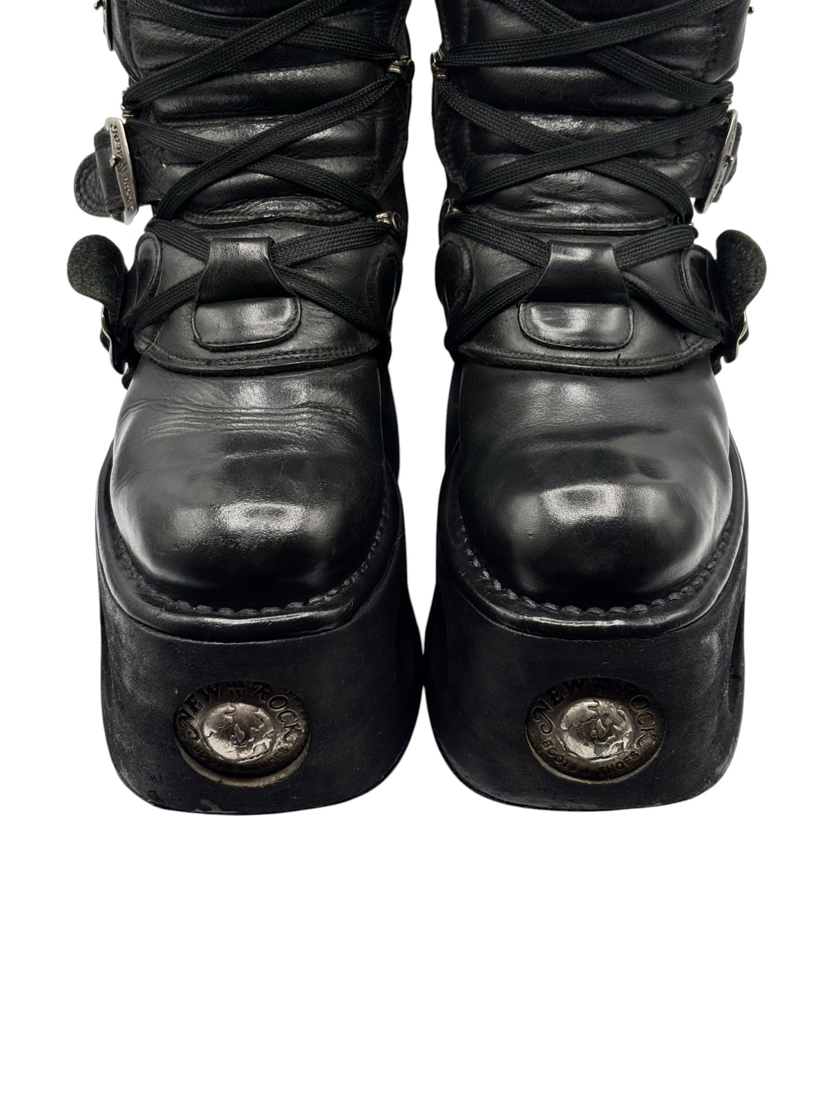 Black platform boots front view with lace-up ties and round decorative metal studs