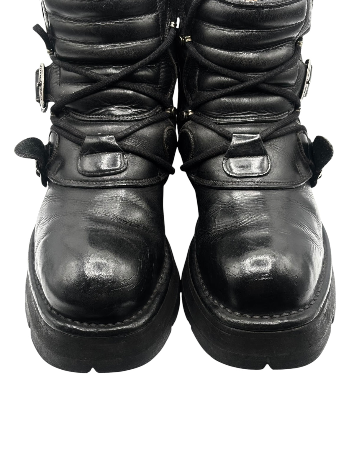 Front view of black raised heel ankle boots with buckled ankle straps