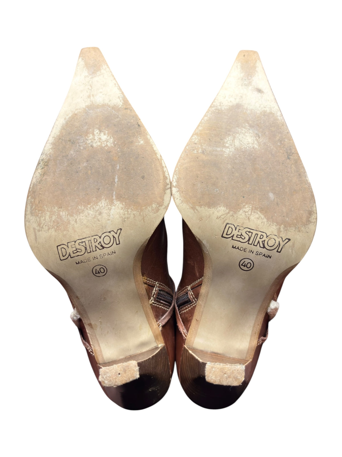 Pair of brown pointy-toe boots showing printed insoles and stiletto heels.