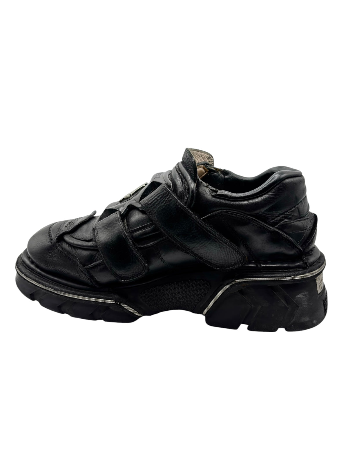 Black leather platform boots with side straps and thick textured sole
