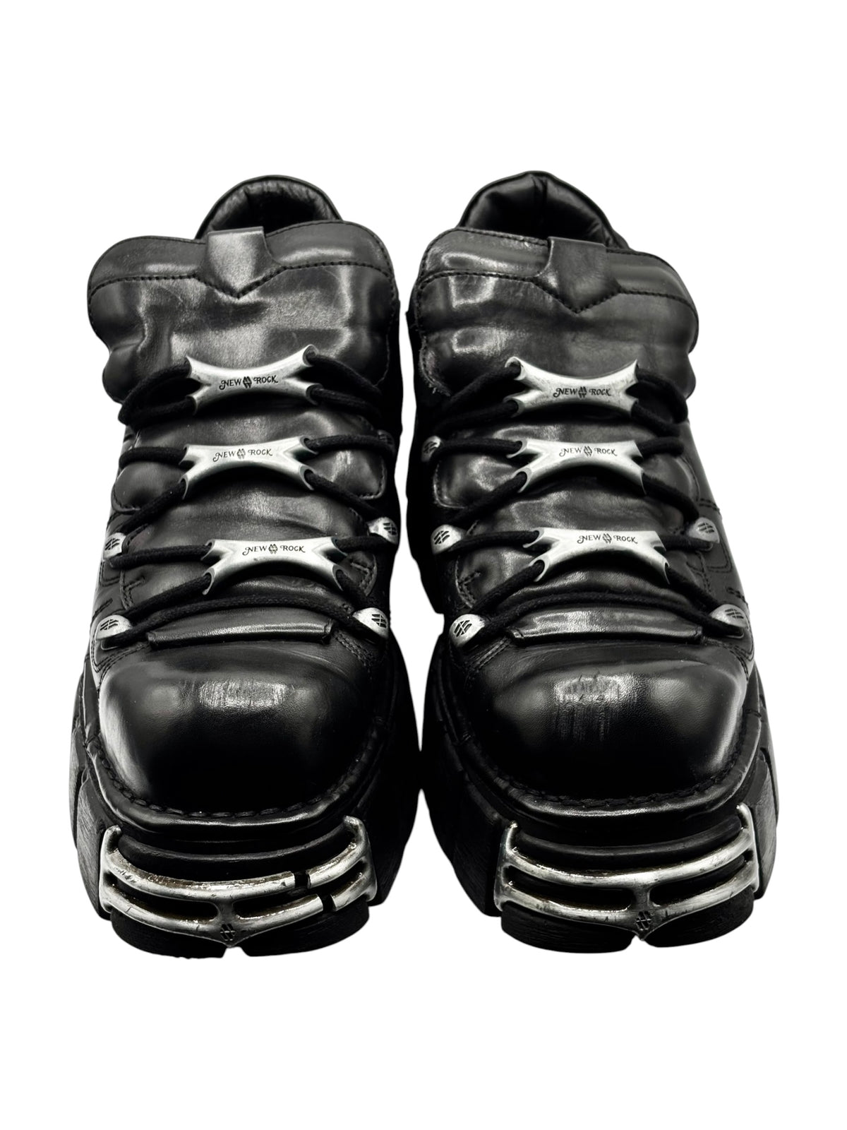 Black platform boots from behind with “New Rock” logo and stacked heel design