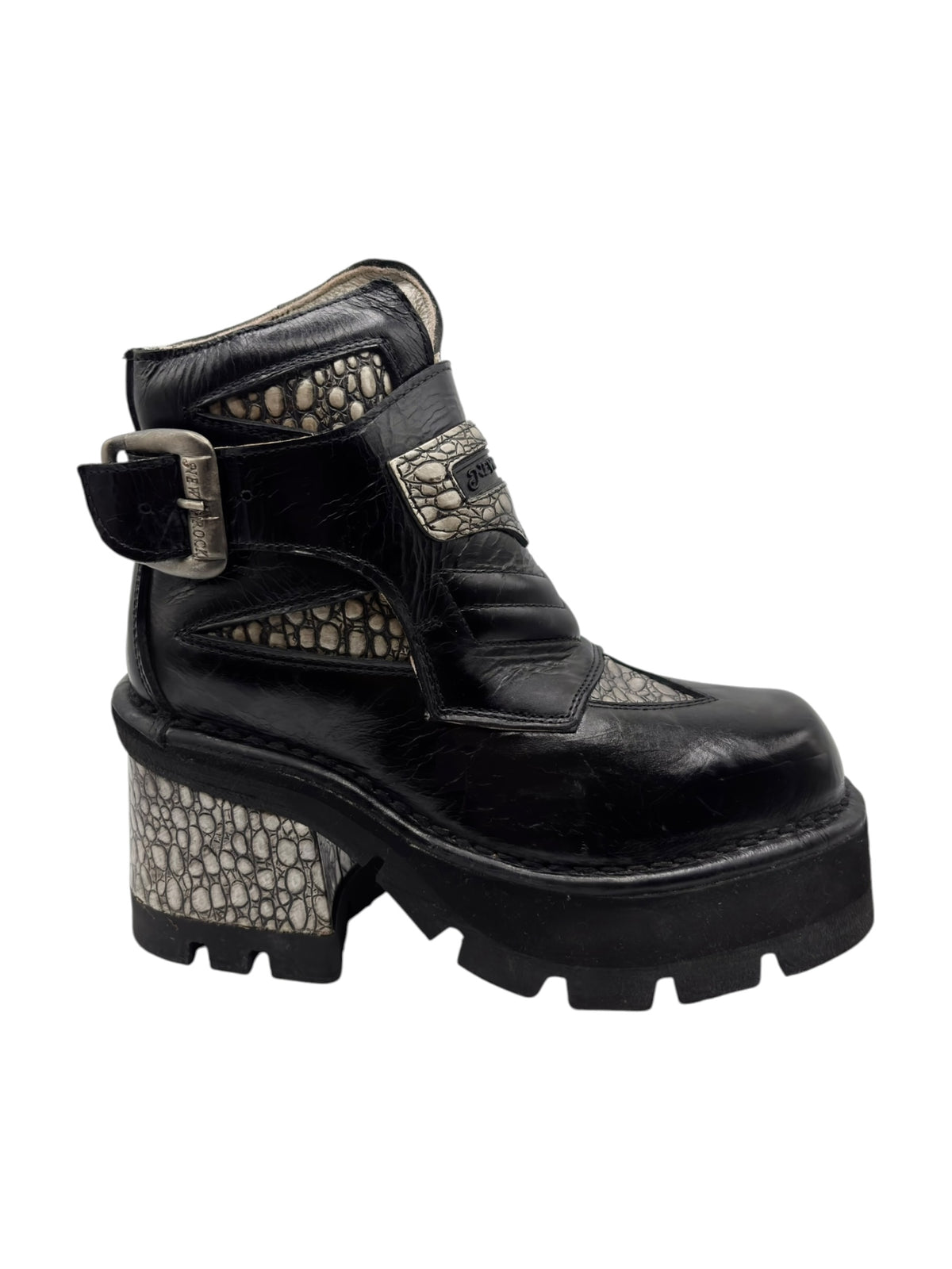 Black platform ankle boot with buckle strap and textured patterned side heel panel.