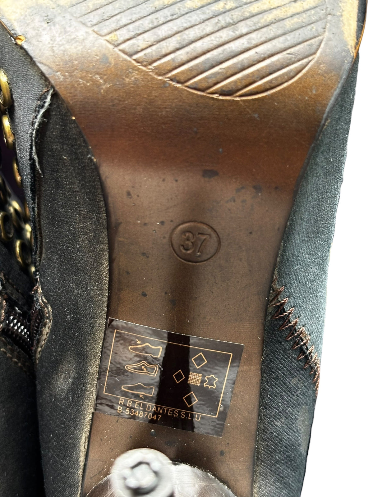 Boot interior view with brand label, footbed, and side seam stitching.