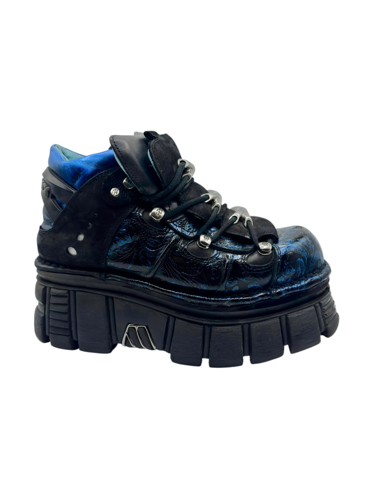 Front three-quarter view of blue patterned platform boots with black chunky sole