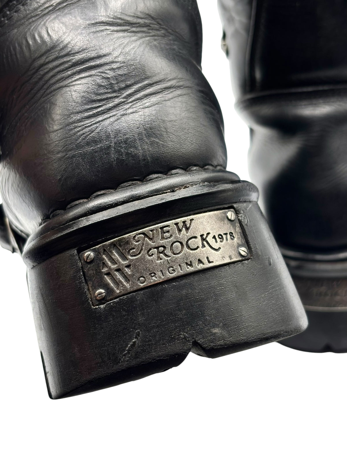 Close-up of boot heel plate with New Rock label and metal edge trim