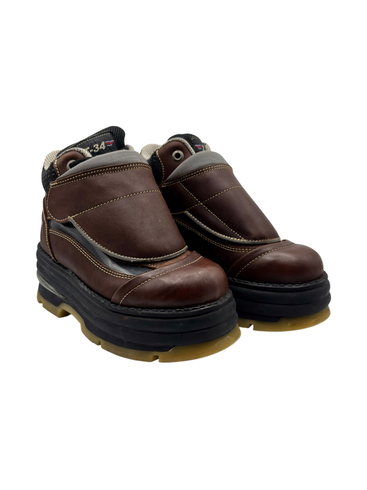 Brown leather boots with dark heel padding, stitched panels, and thick black platform sole.