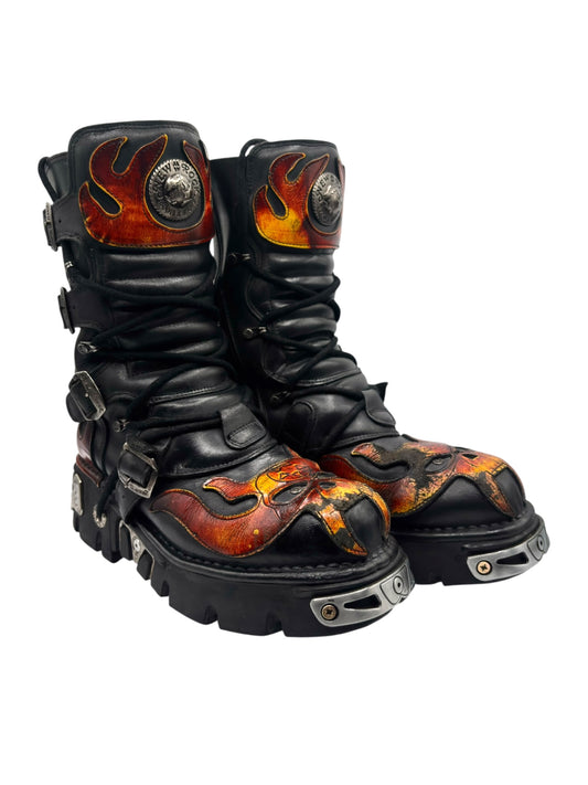 Two black leather boots with orange flame toe panels and rugged tread soles