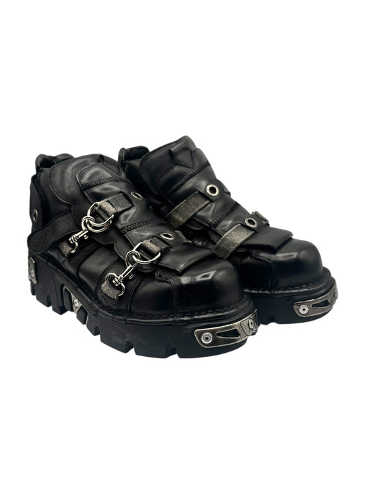 Black platform boots with dual buckled straps and chunky tread sole